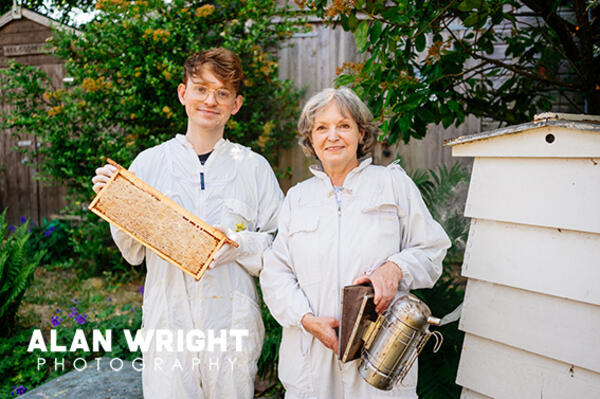 Elizabeth Ready and son Joseph tend to bees in the garden of their Horsham home (©AAH/Alan Wright)