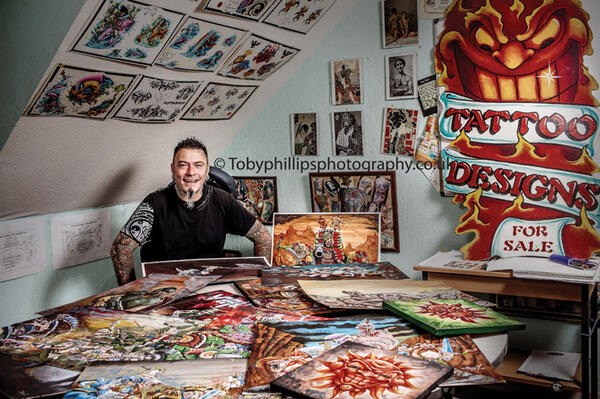 Danny Fuller with some of his colourful paintings