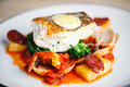Pan-fried cod fillet with chorizo, roasted red pepper, black olives and clams