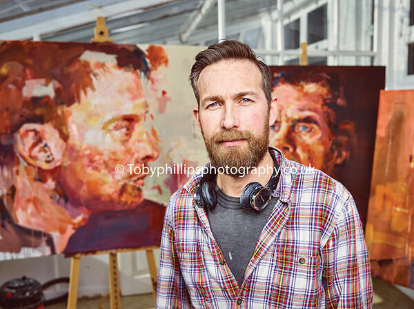 Jeremy Bridle with his portraits