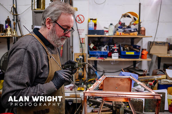 Coppersmith Alan Jordan works on a Windsor lantern at William Sugg & Co (©AAH/Alan Wright)